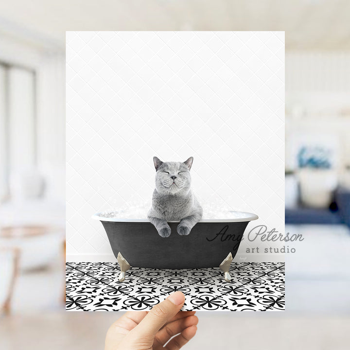 a person holding up a card with a cat in a bathtub