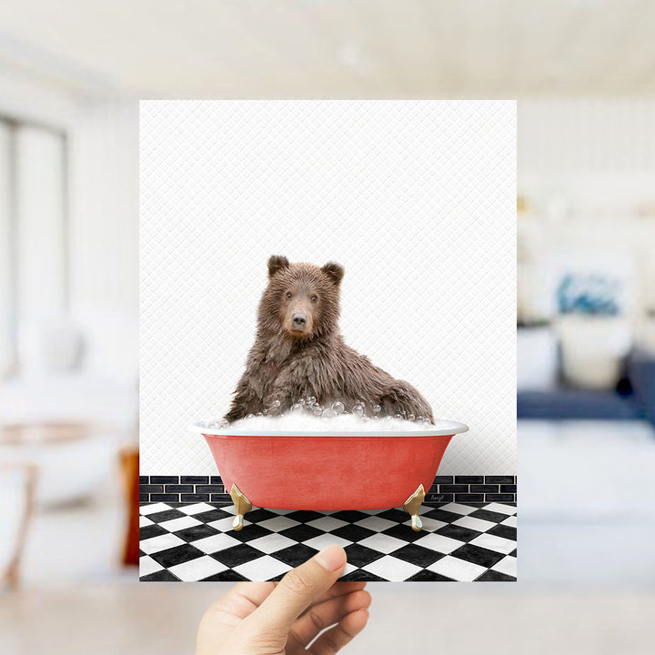 A brown bear sitting in a red bathtub filled with bubbles, with a black and white checkered floor in the background.