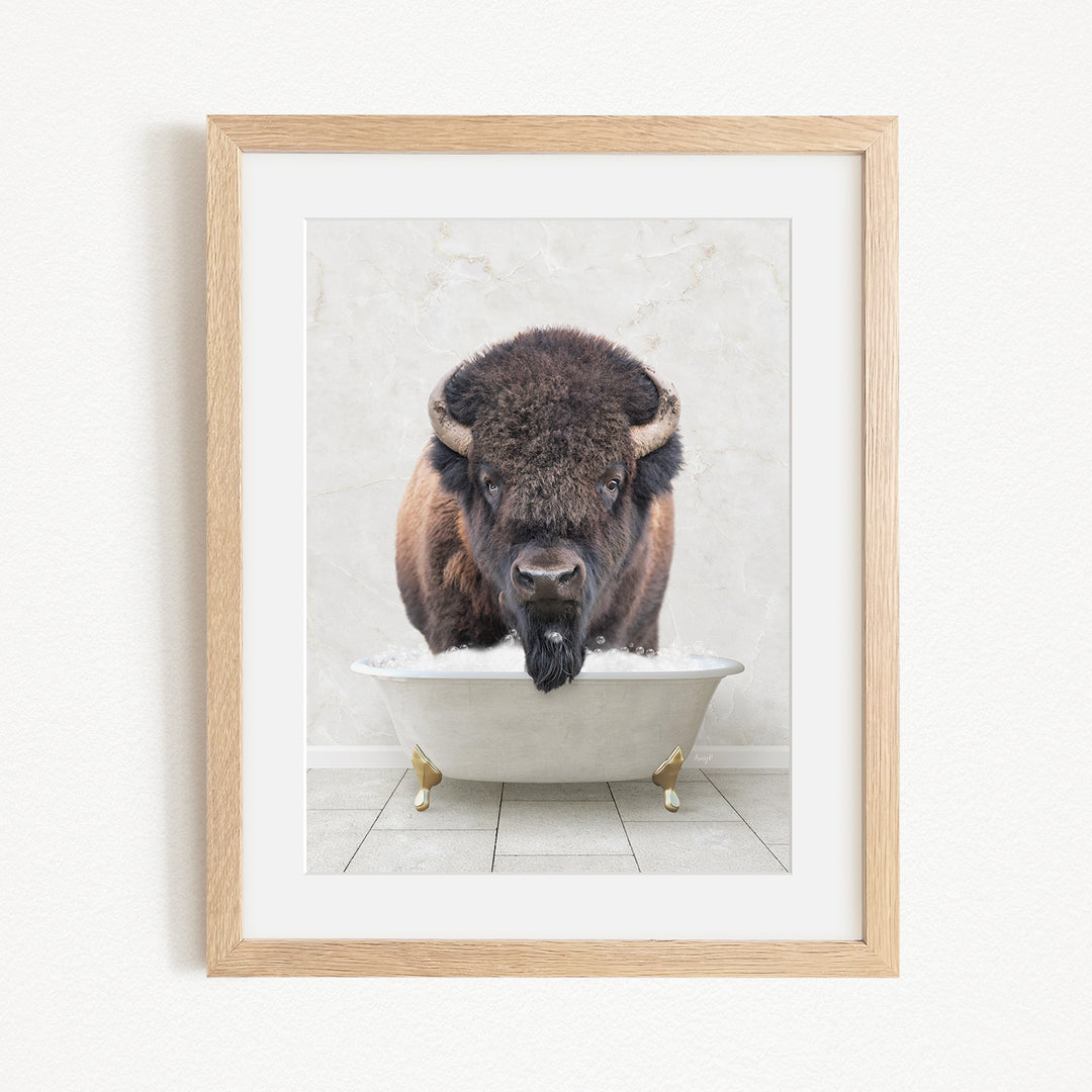 A buffalo with large horns is standing in a white bathtub filled with water, appearing to be enjoying a bath.