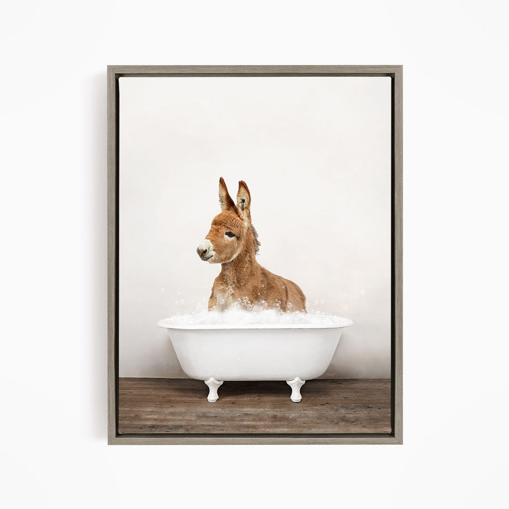 A donkey is sitting in a white bathtub filled with bubbles, creating a playful and whimsical scene.
