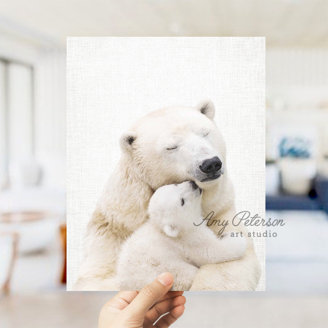 a polar bear holding a baby polar bear