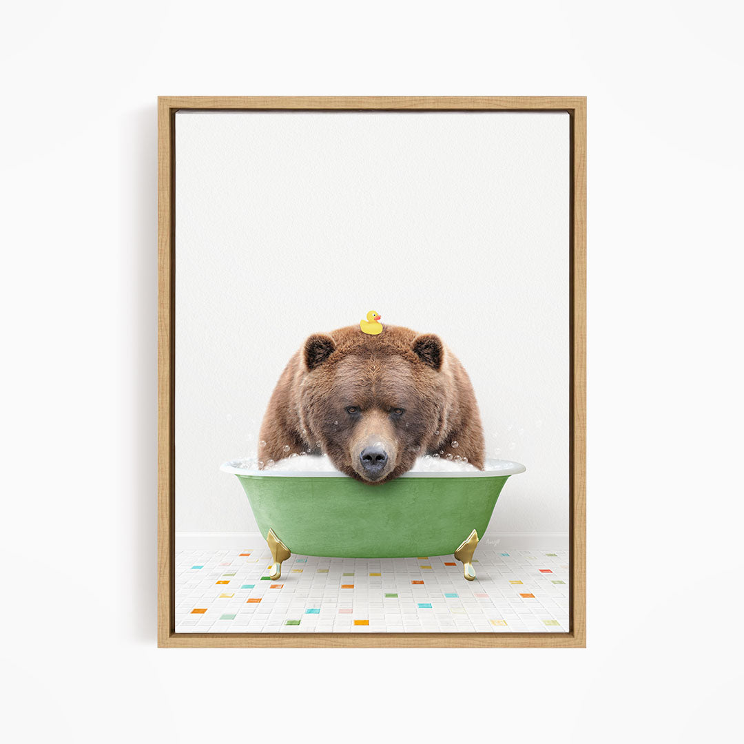 A brown bear is sitting in a green bathtub, with a yellow rubber duck perched on its head.