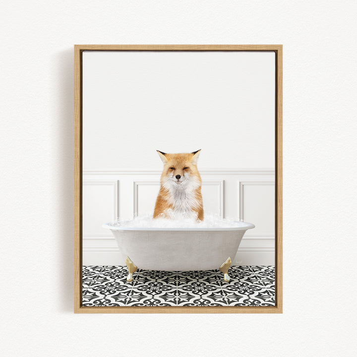 A red fox sitting in a white bathtub filled with bubbles, looking directly at the camera.