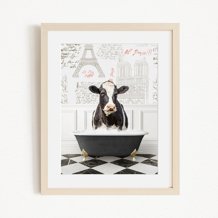 A black and white cow is sitting in a bathtub filled with water, surrounded by a Paris-themed background with the Eiffel Tower and other landmarks.