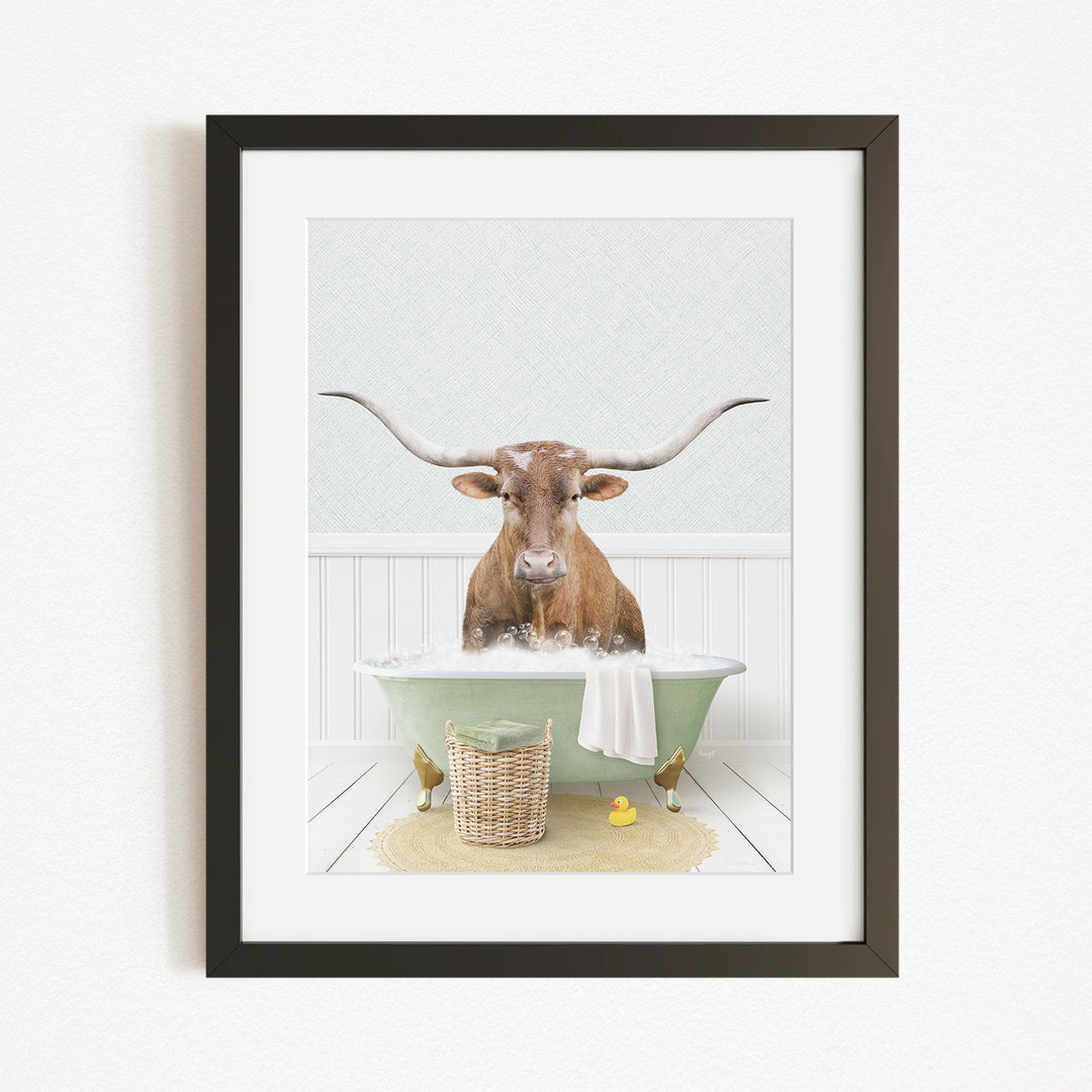 A brown bull with long horns is sitting in a green bathtub filled with water, surrounded by a basket of rubber ducks and a yellow rubber ducky.