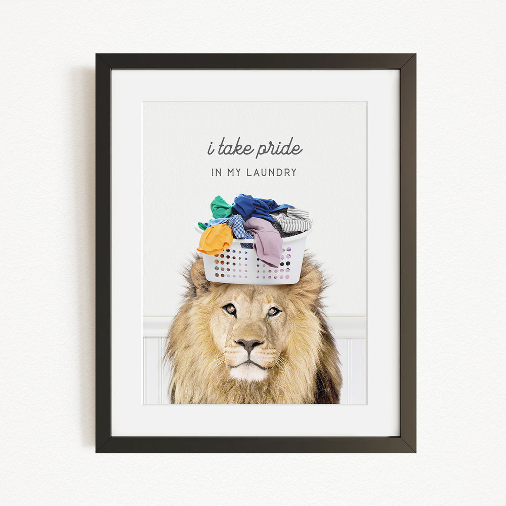 A framed image of a lion with a basket of laundry on its head, accompanied by the text "I take pride in my laundry".