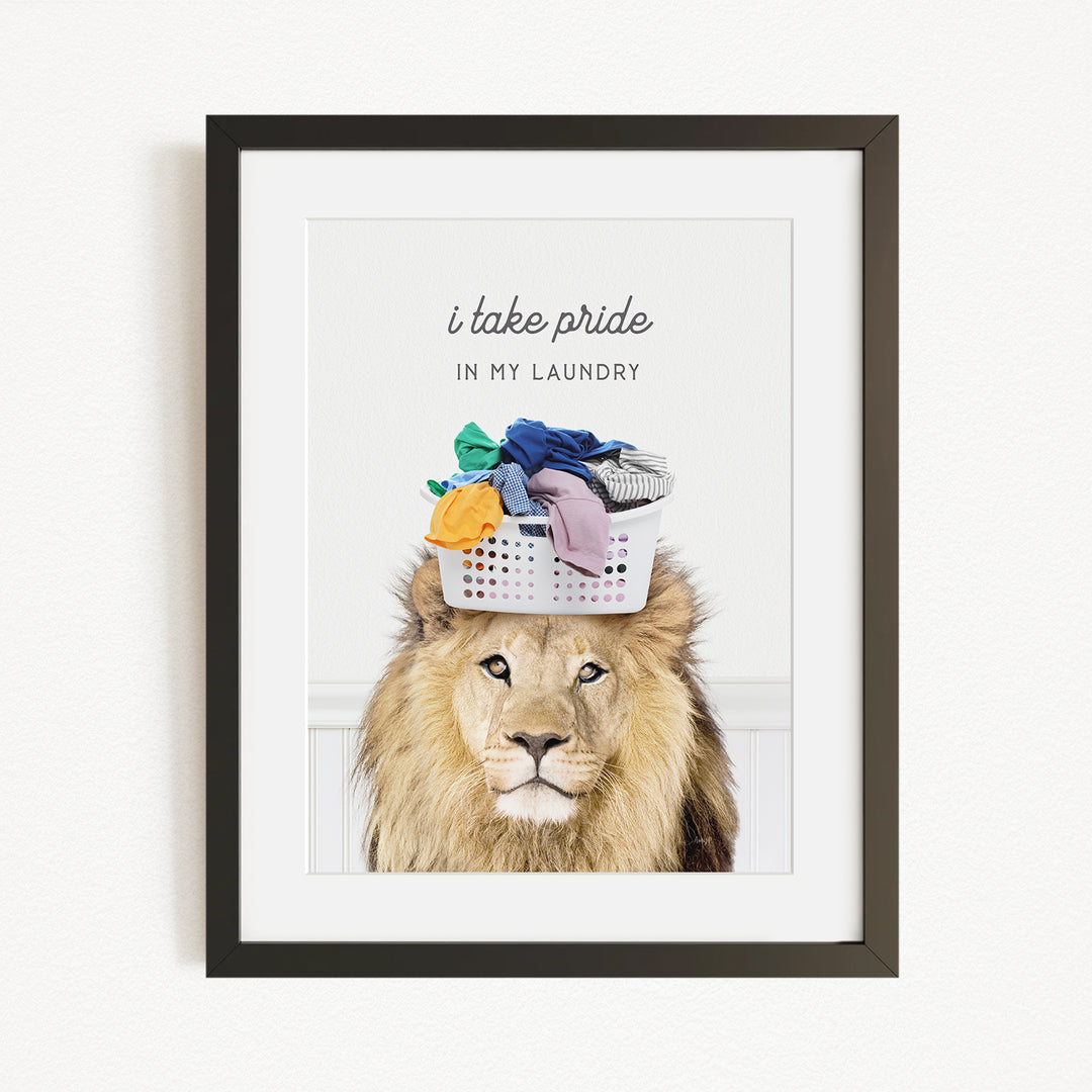 A framed image of a lion with a basket of laundry on its head, accompanied by the text "I take pride in my laundry".