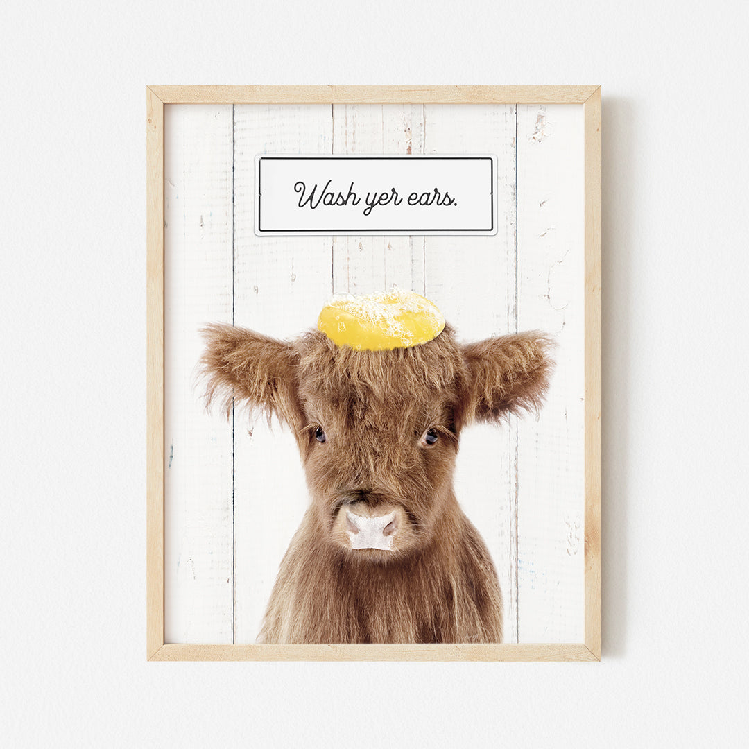 a picture of a cow with a yellow hat on it's head