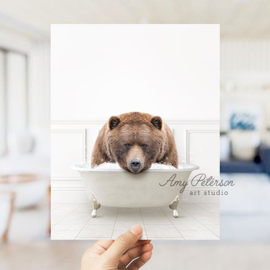 a person holding up a polaroid picture of a bear in a bathtub