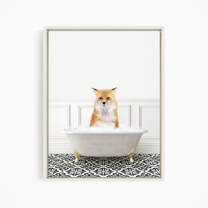 A red fox is sitting in a white bathtub filled with bubbles, looking directly at the camera.