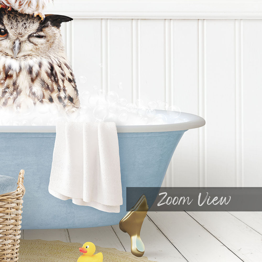 A close-up of a blue bathtub filled with water, with a small owl sitting inside and a yellow rubber duck floating nearby.
