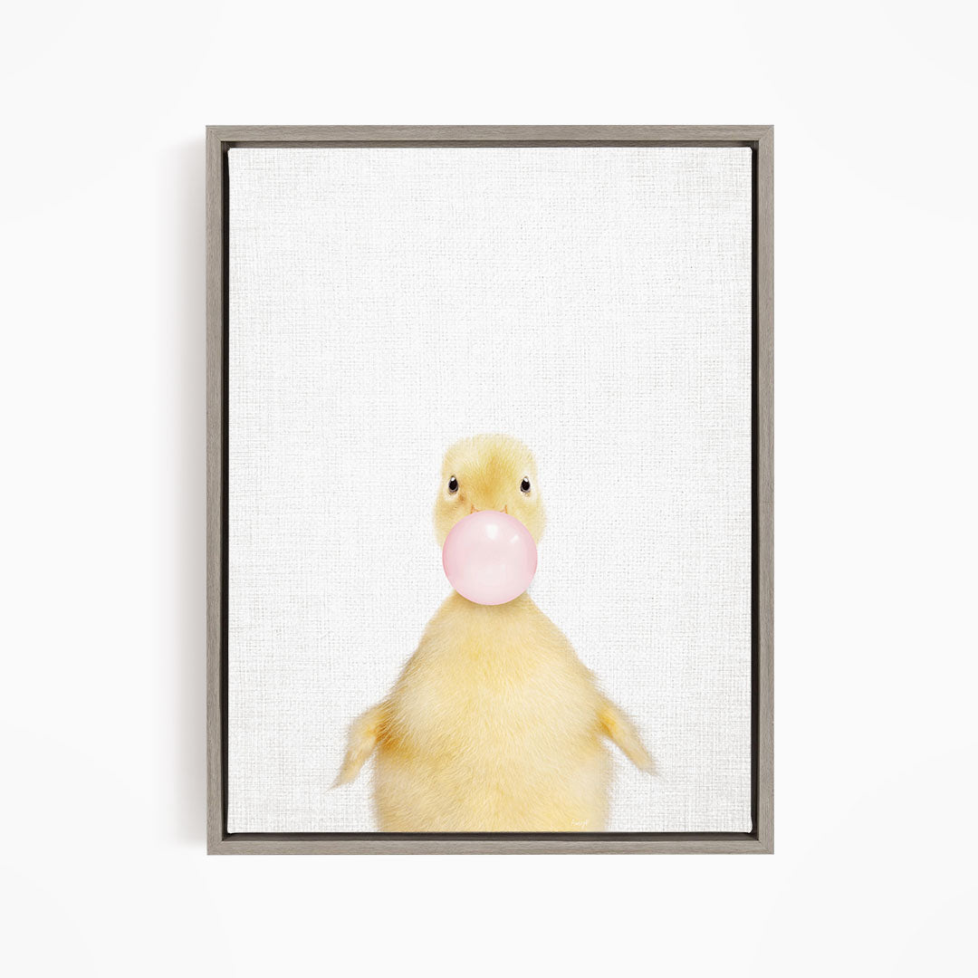 A cute yellow duck blowing a bubble with a pink bubble gum bubble.