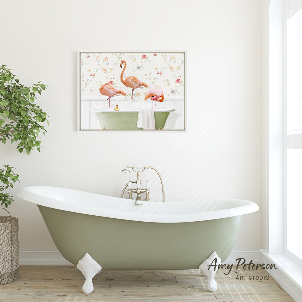 a bathroom with a green clawfoot bathtub, a framed painting of two pink flamingos in a bathtub, and a potted plant on the side.