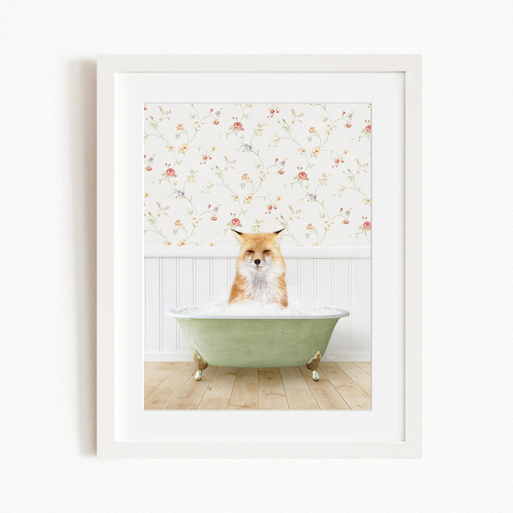 A fox is sitting in a green bathtub filled with bubbles, with a floral wallpaper in the background.