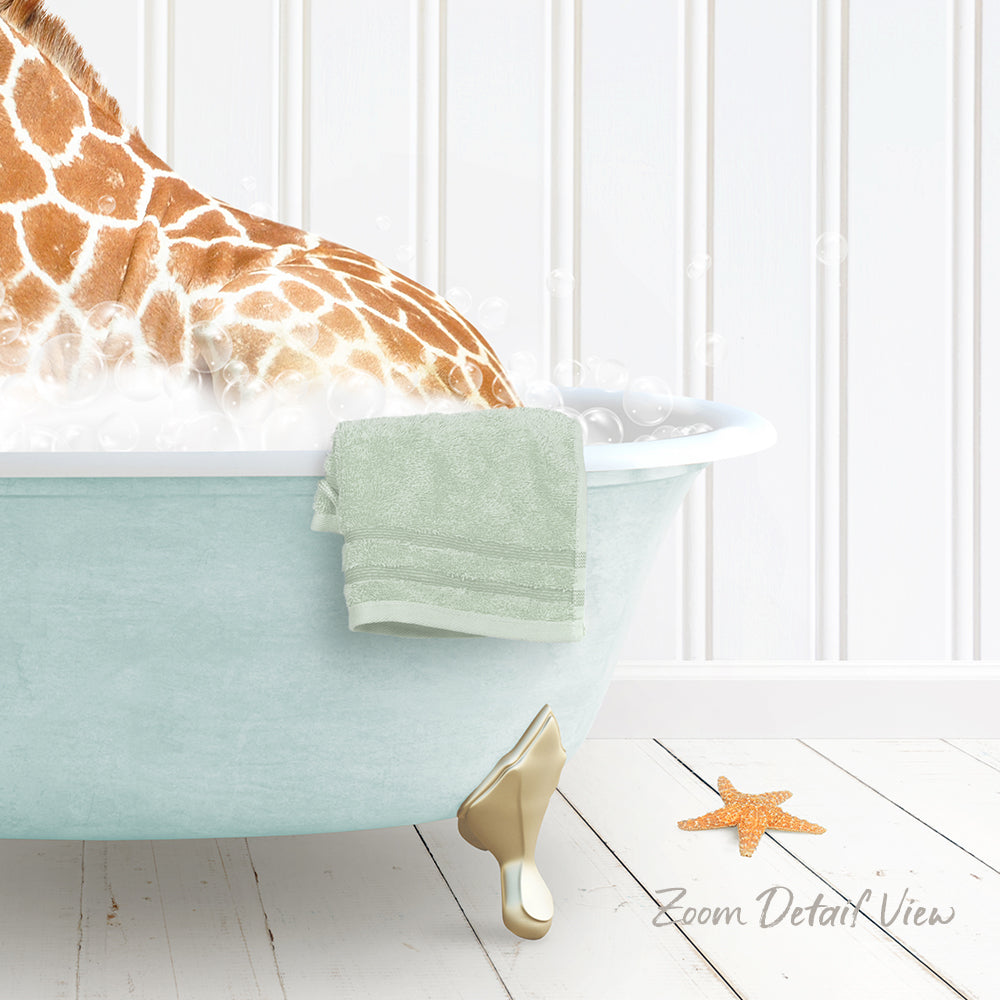 A giraffe is sitting in a light blue bathtub filled with water, with a green towel hanging on the side and a starfish on the floor next to the tub.