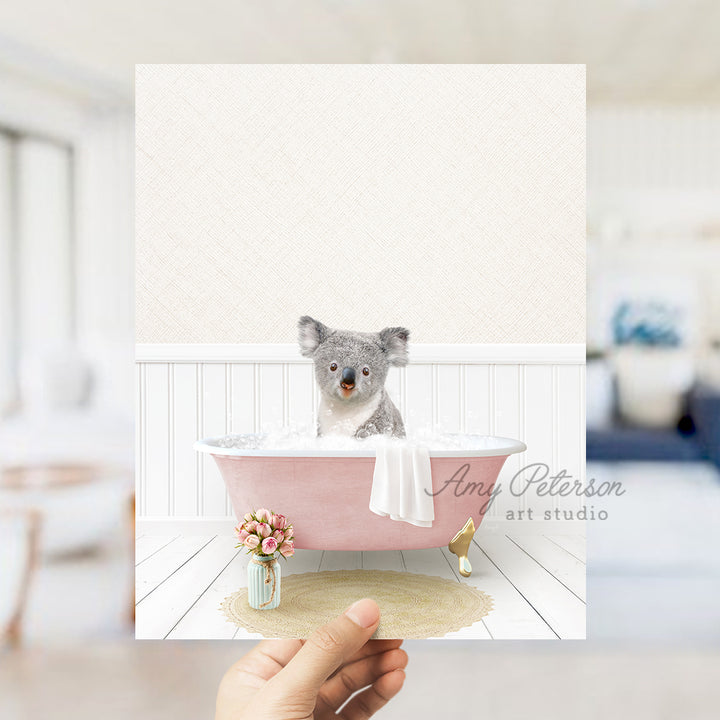 a person holding a card with a picture of a koala in a bathtub