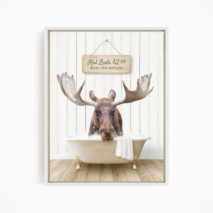 A moose with large antlers is sitting in a bathtub, with a sign above it that reads "Hot Bath $2.00 WASH YER ANTLERS".
