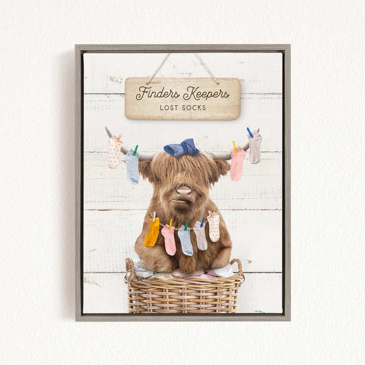 A brown cow sitting in a wicker basket, surrounded by colorful socks hanging from clotheslines.