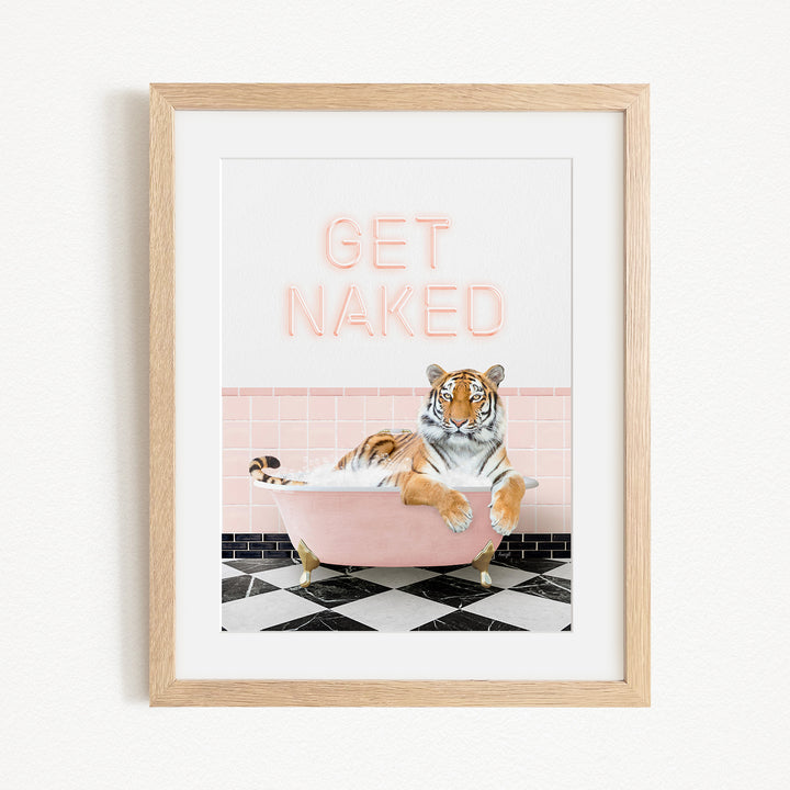A framed print featuring a tiger sitting in a pink bathtub with the text "GET NAKED" displayed above it.
