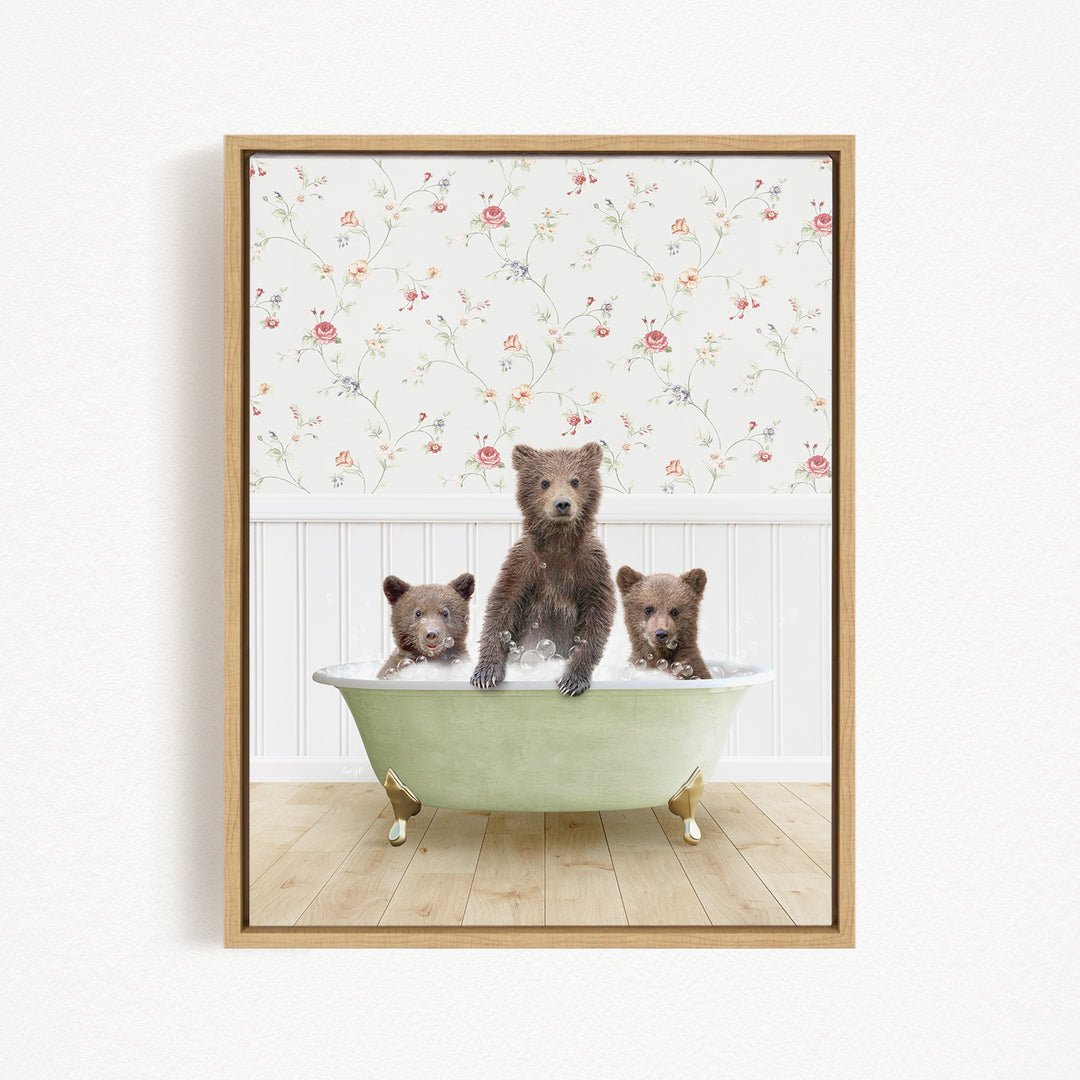A framed image depicting three bears sitting in a green bathtub, with a floral wallpaper in the background.
