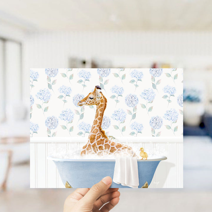 A giraffe sitting in a blue bathtub filled with water, surrounded by blue hydrangea flowers.
