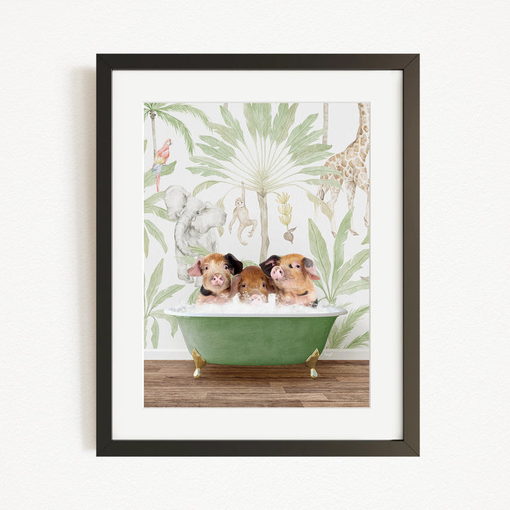 A framed print depicting three pigs sitting in a green bathtub, surrounded by a tropical jungle wallpaper.