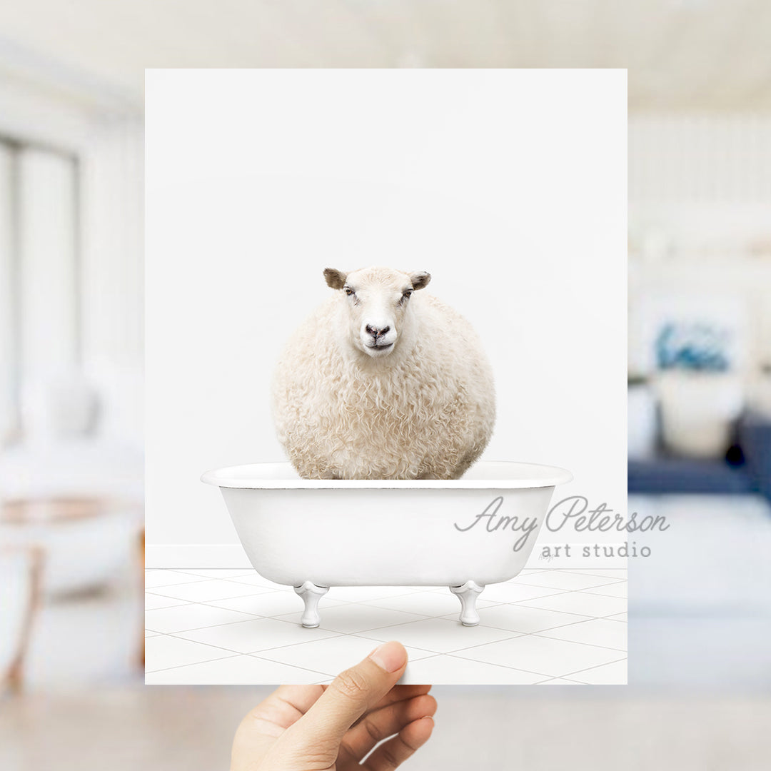 a hand holding a card with a sheep in a bathtub