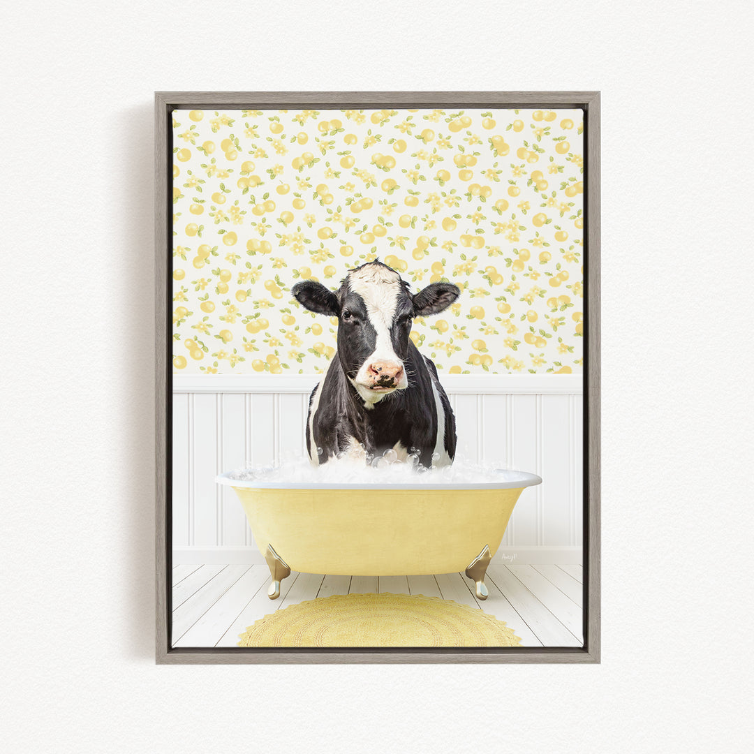 A black and white cow is sitting in a yellow bathtub filled with water, surrounded by a yellow and white floral patterned wall.