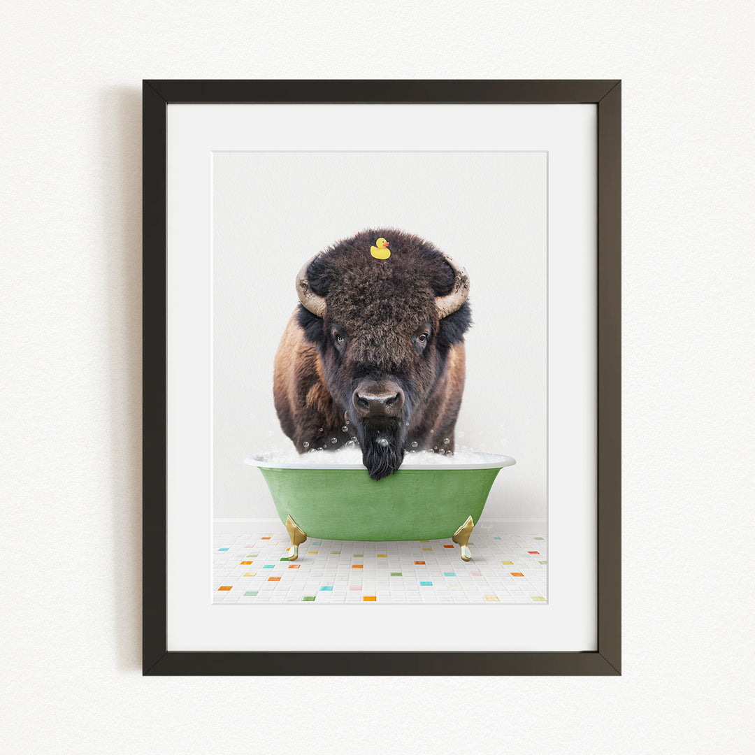 A buffalo with a yellow rubber duck sitting in a green bathtub.