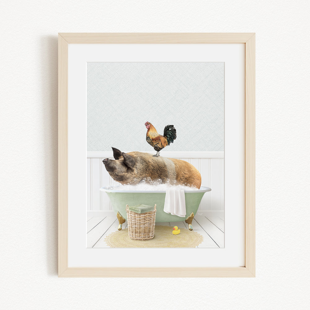 A framed image depicting a pig sitting in a bathtub, with a rooster perched on its back, and a basket of rubber ducks nearby.