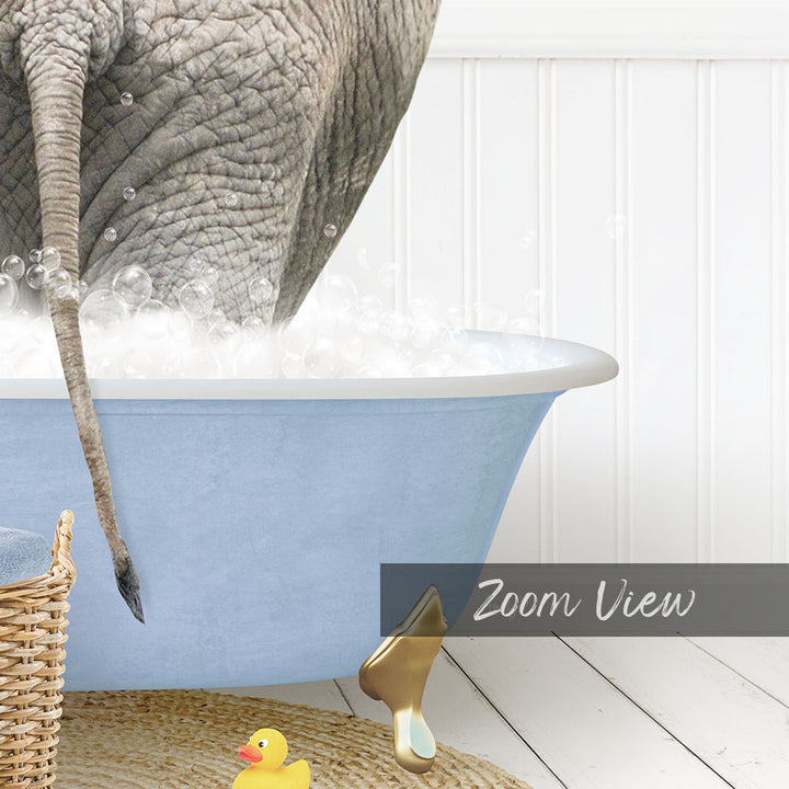 A gray elephant is standing in a blue bathtub filled with bubbles, with a yellow rubber duck nearby and a basket of toys on the floor.