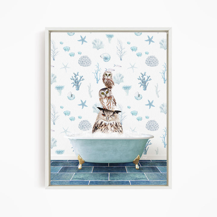A framed print depicting a whimsical scene of three owls sitting in a bathtub, surrounded by a blue and white ocean-themed wallpaper.