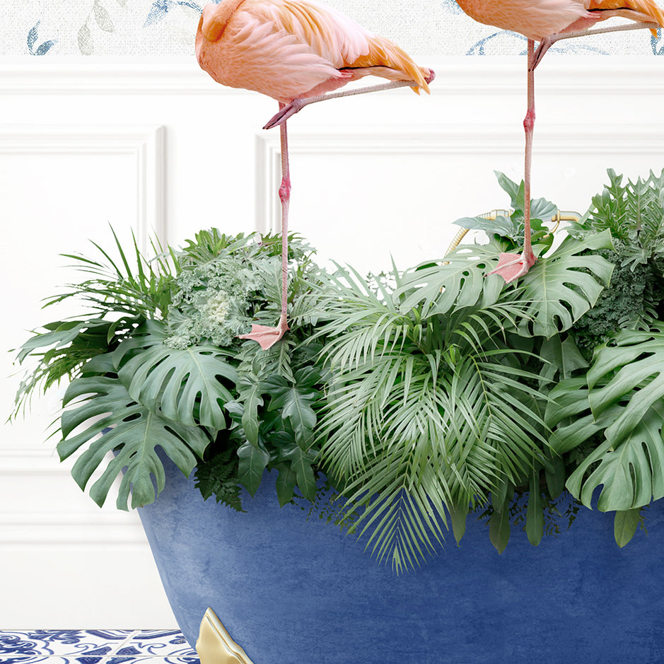 two pink flamingos standing on top of a blue planter