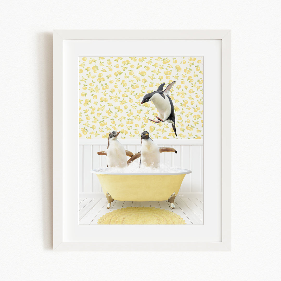 A framed image depicting three penguins sitting in a yellow bathtub, with one penguin standing on the edge of the tub and another penguin sitting inside the tub.