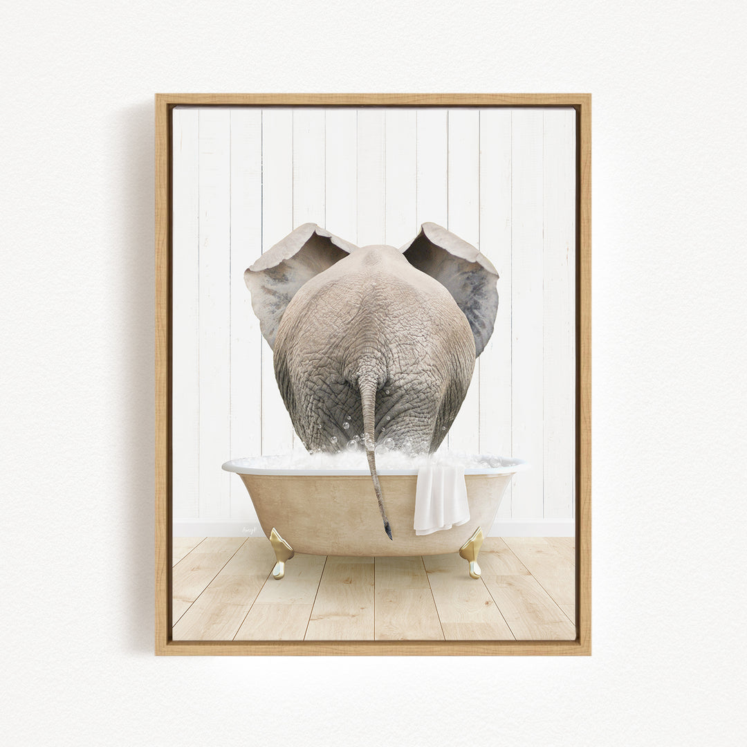 A gray elephant is sitting in a white bathtub filled with water, with its trunk submerged in the water.