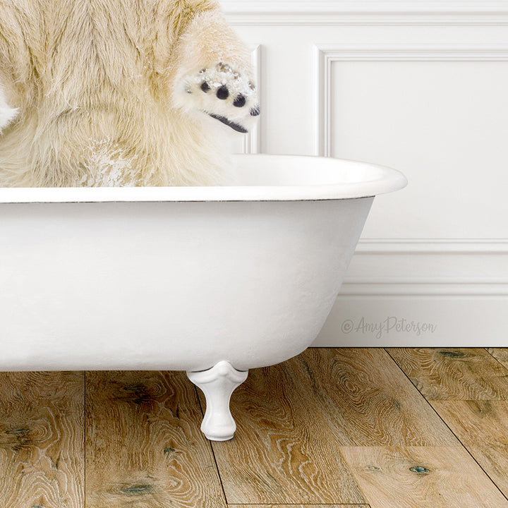 A white polar bear is sitting in a white bathtub, with its paw raised in the air.