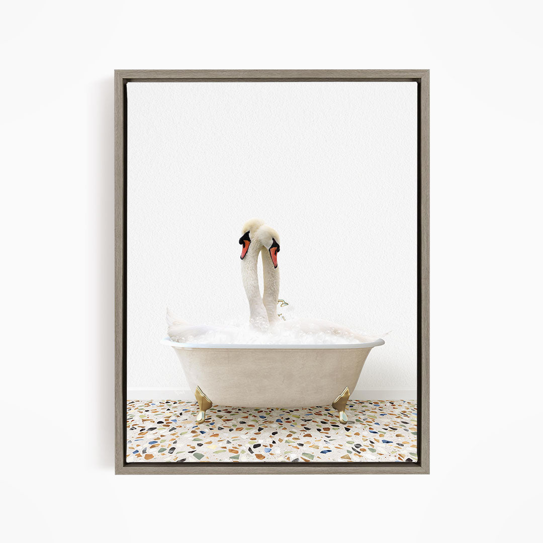 A pair of swans standing in a white bathtub filled with water, with a speckled floor beneath them.