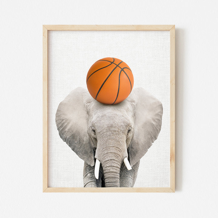 a picture of an elephant with a basketball on its head