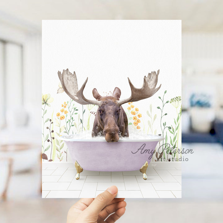 a person holding up a card with a picture of a moose in a bathtub