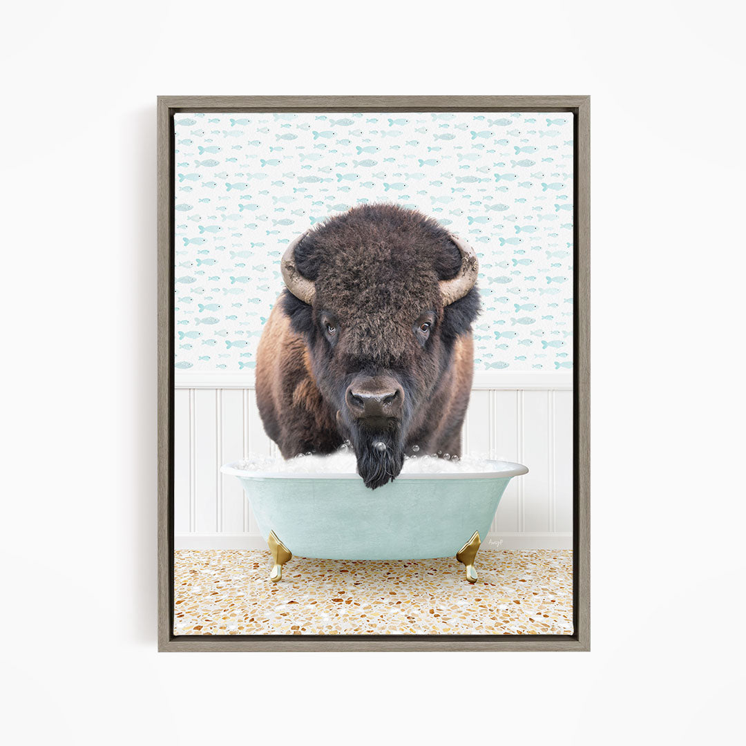 A buffalo with large horns is standing in a bathtub filled with water, creating a whimsical and humorous scene.