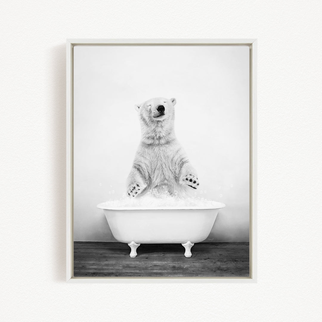 A polar bear standing in a white bathtub filled with water, appearing to be enjoying a bath.