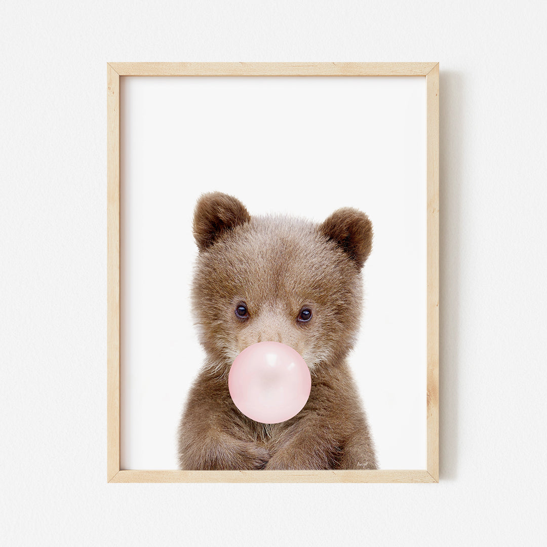 a teddy bear with a bubble gum in its mouth