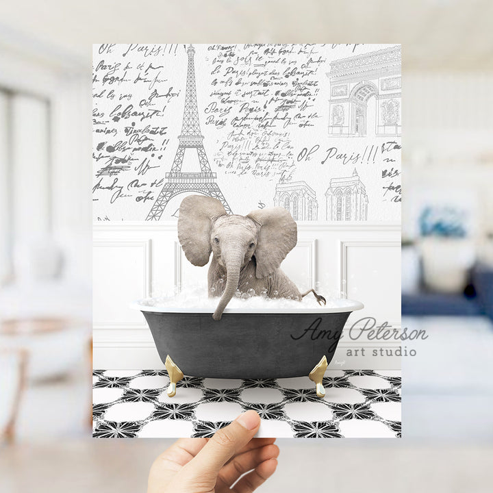 a person holding up a card with an elephant in a bathtub