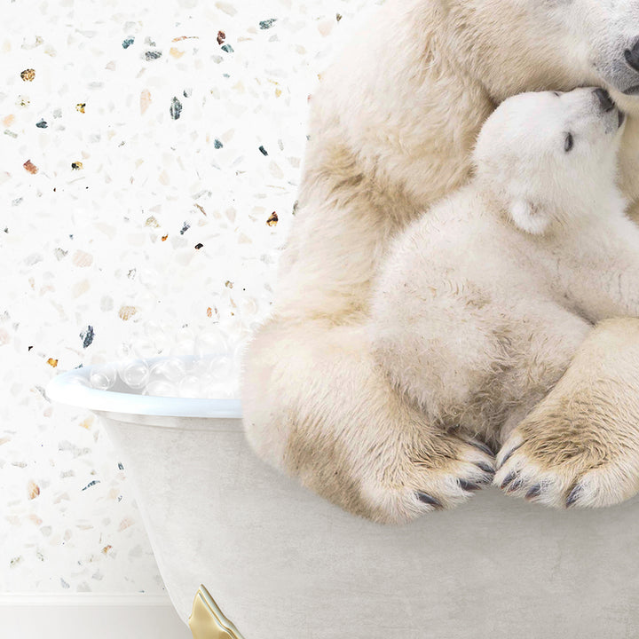 a mother polar bear cuddles her cub in a bathtub