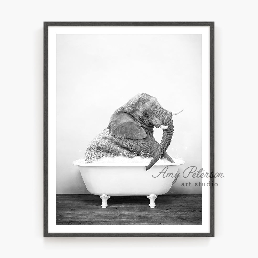 a black and white photo of an elephant in a bathtub