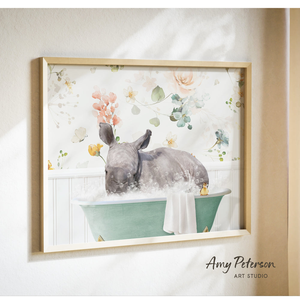 A framed print depicting a rhinoceros sitting in a green bathtub filled with bubbles, surrounded by a floral pattern.