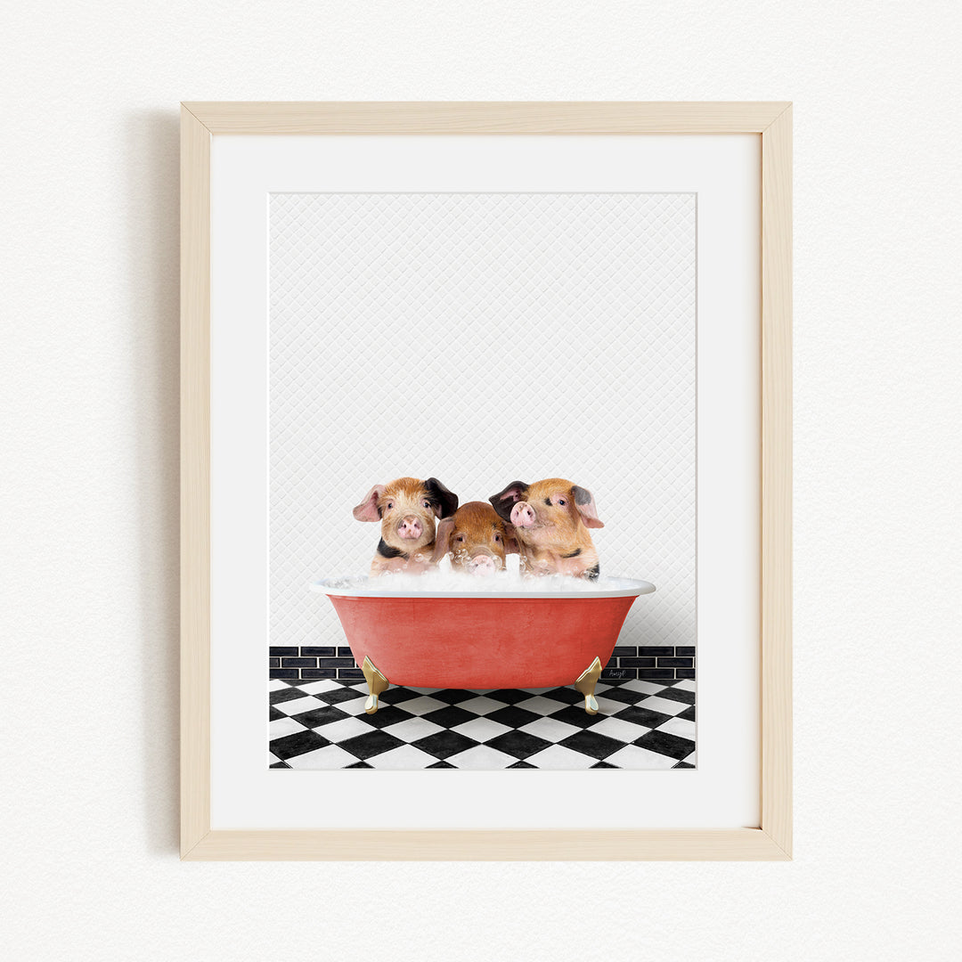 Three adorable pigs sitting in a red bathtub on a black and white checkered floor.