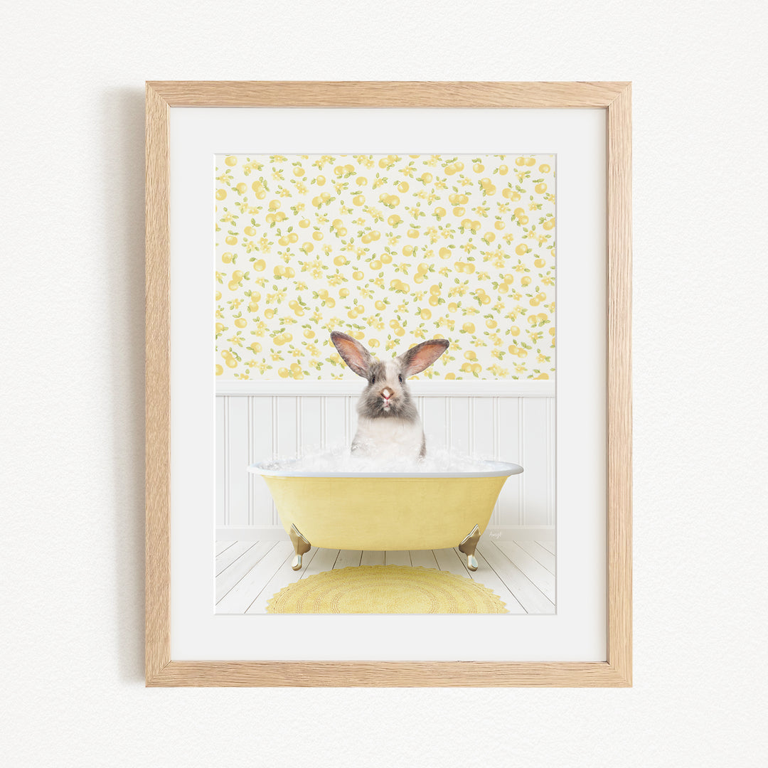 A cute rabbit sitting in a yellow bathtub filled with bubbles, surrounded by a yellow floral pattern on the wall behind it.