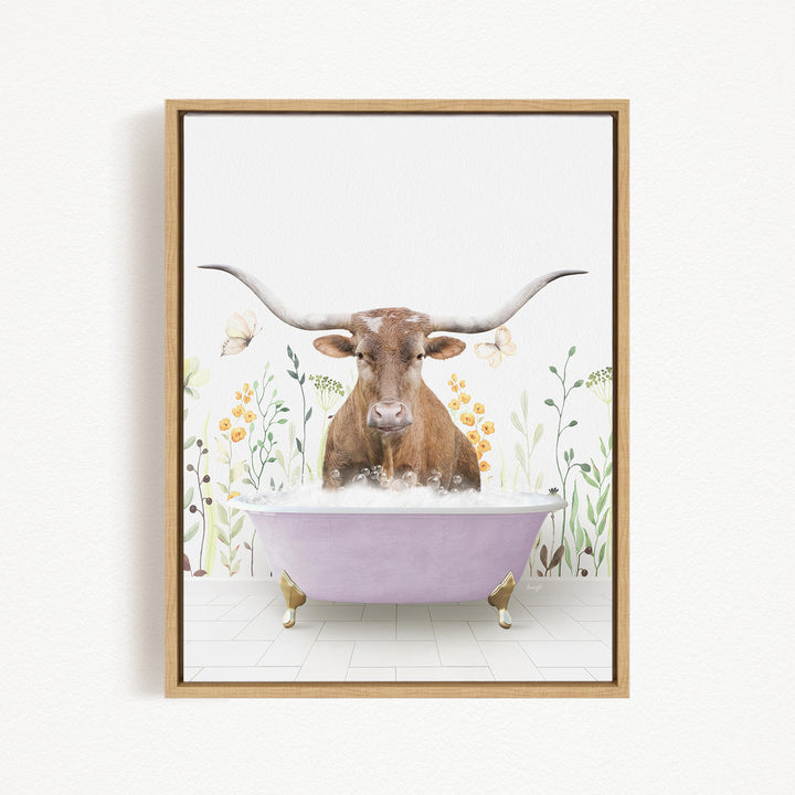 A brown cow with large horns is sitting in a pink bathtub filled with bubbles, surrounded by flowers and plants.