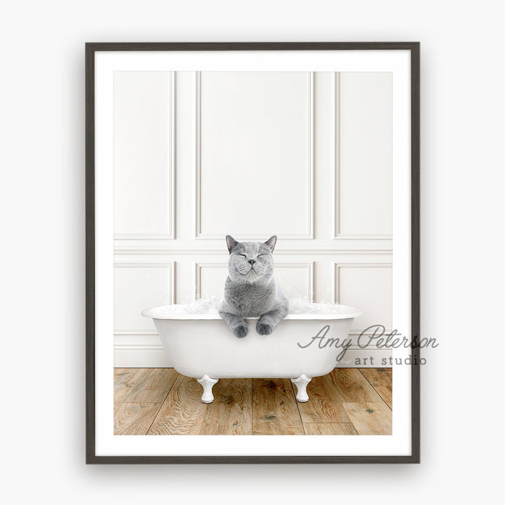 a gray cat sitting in a white bath tub